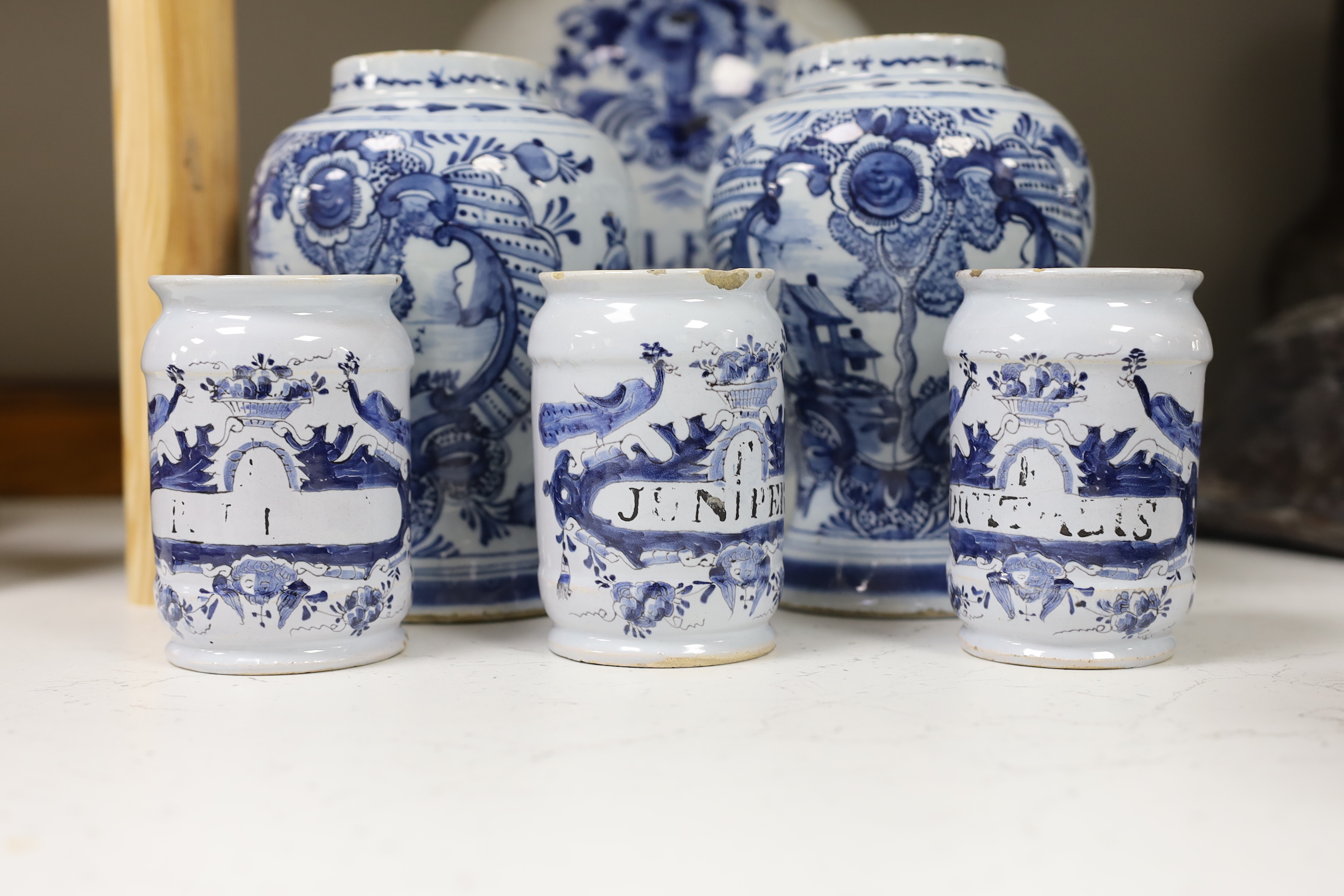 A set of three 18th century Delft drug jars, a similar large Violetta jar, Duyn mark, and a pair of 18th century Delft vases, tallest 28cm high